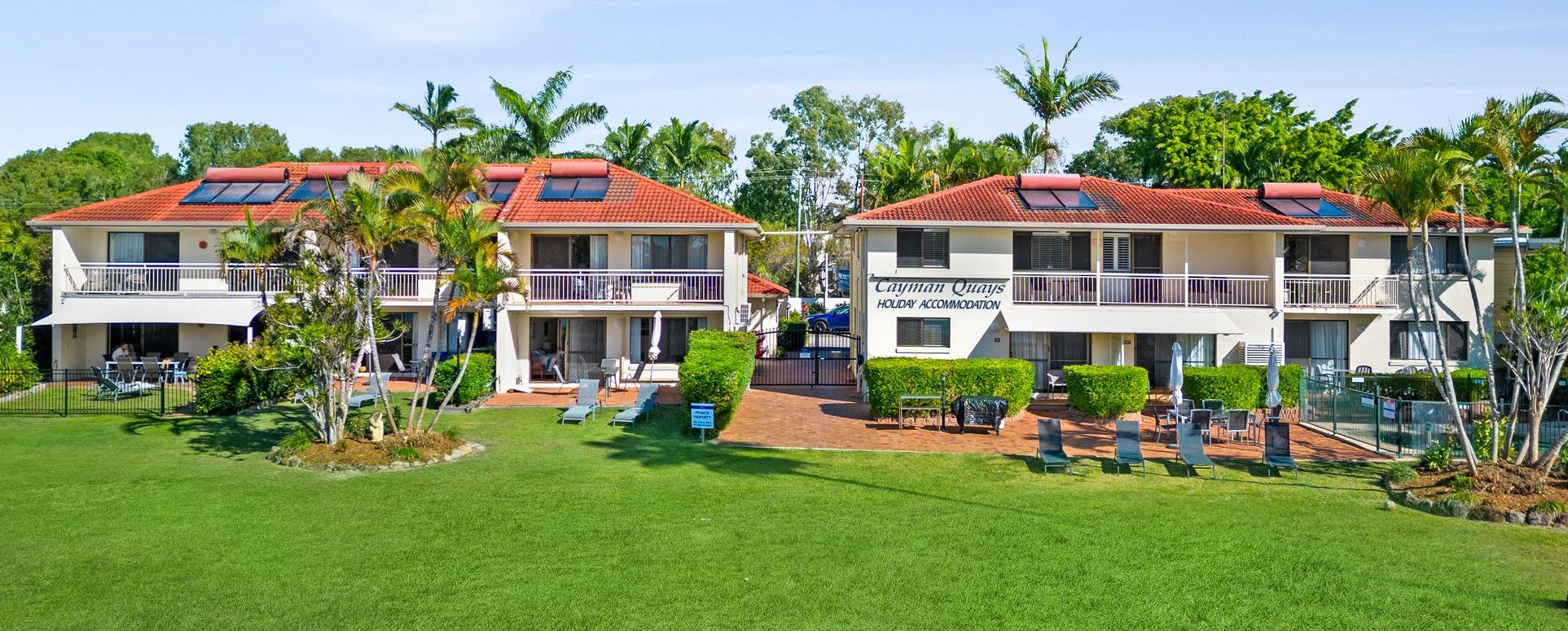 Waterfront view of the north-facing Cayman Quays apartment building complex shot directly from the Noosa River.