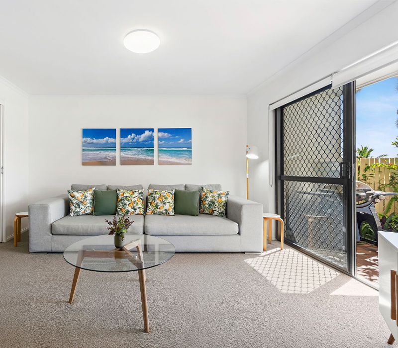 The secondary separate lounge and media room inside the four-bedroom townhouse, offering flexible breakout space for multi-generational families and opening directly to the patio.