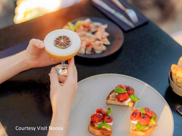 Close-up of a premium 5-star restaurant dish and gourmet cocktail, showcasing the celebrated dining scene near Noosa River.