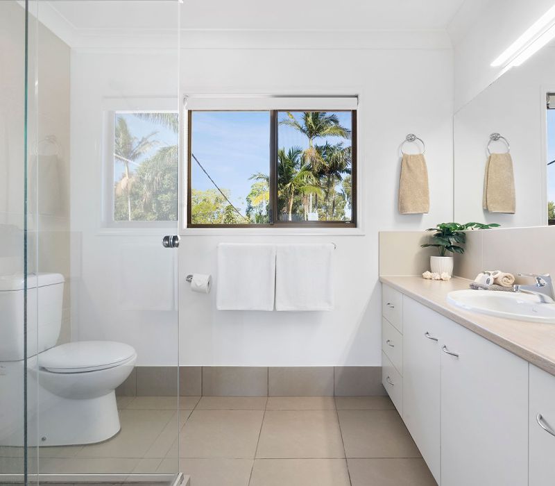 One of the three clean and modern bathrooms inside our premium four-bedroom holiday townhouse at Cayman Quays, featuring contemporary fixtures.