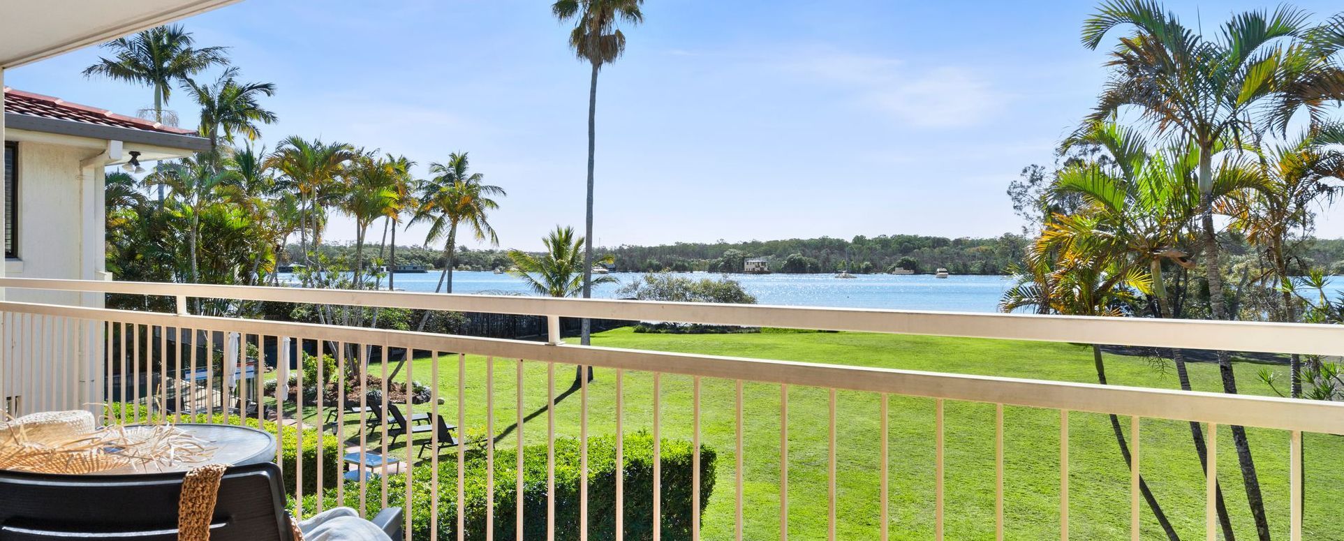 Scenic view of the absolute waterfront and pristine parklands of the Noosa River taken directly from a private apartment balcony at Cayman Quays Noosaville