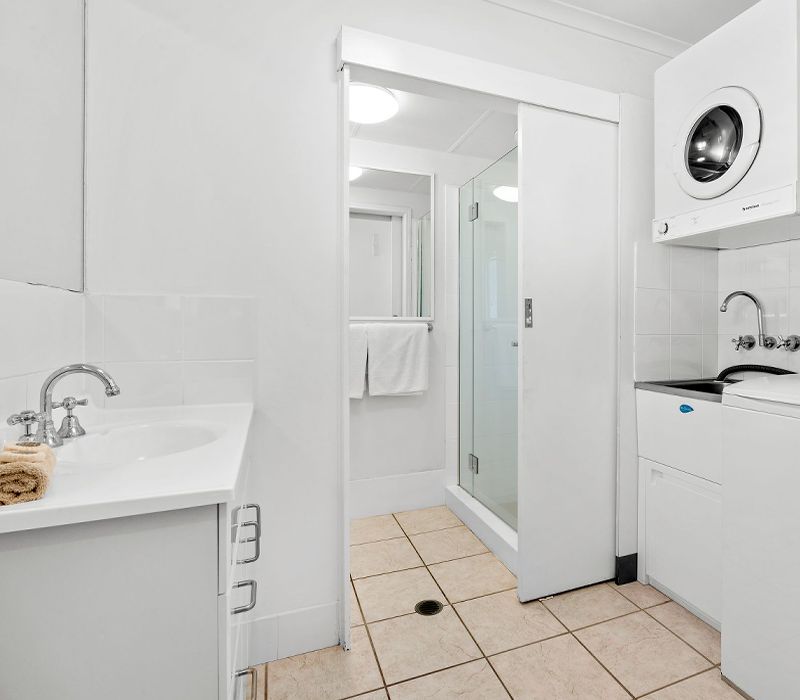 The integrated townhouse ground-floor laundry room utility area seamlessly connected off of one of the full bathrooms for maximum group holiday convenience.