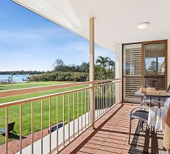 Private upper-level balcony of Unit One at Cayman Quays, showcasing spectacular, uninterrupted panoramic views directly over the Noosa River waterfront.